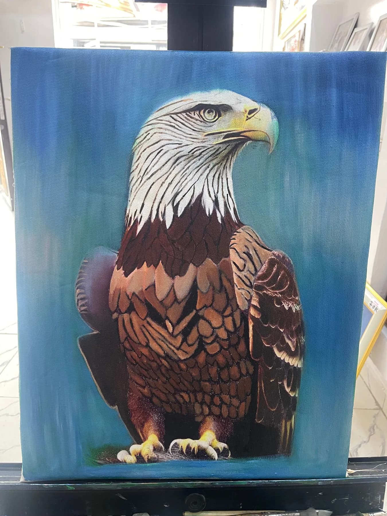 Bald eagle painting on a blue background